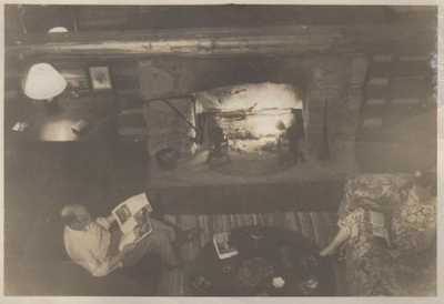 My aunt and uncle by the fireplace inside the cabin